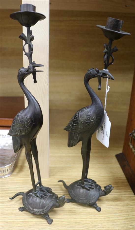 A pair of Chinese bronze crane candlesticks